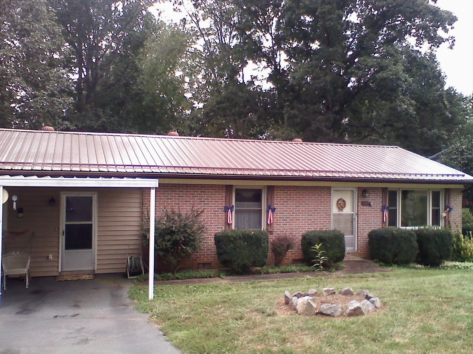 Bronze metal roof and carport on a brick ranch home — Roof Repair work by our crew in Turon