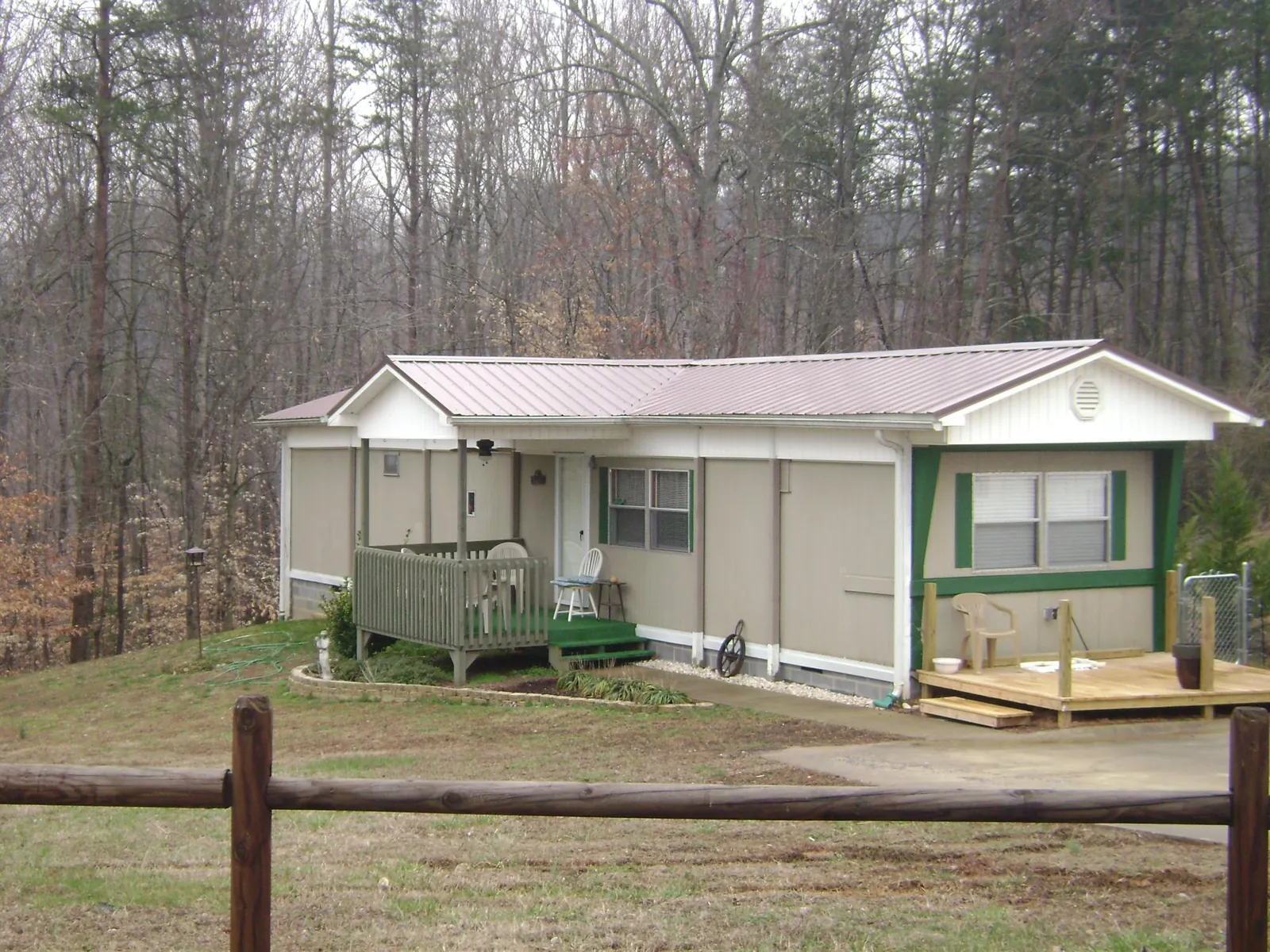 Mauve metal roof on a manufactured home with a new front deck in Turon